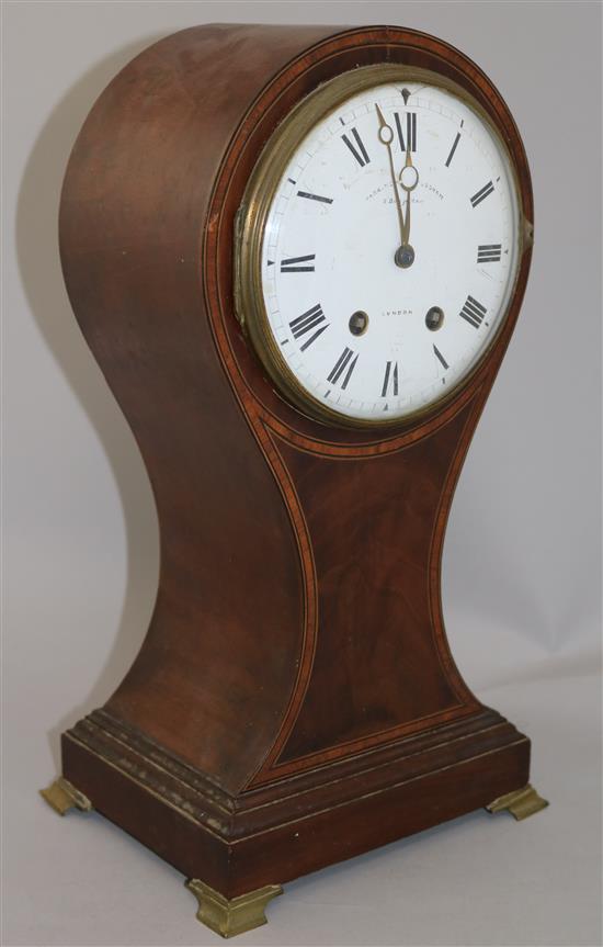 An Edwardian cross banded mahogany balloon cased mantel clock, 15in.